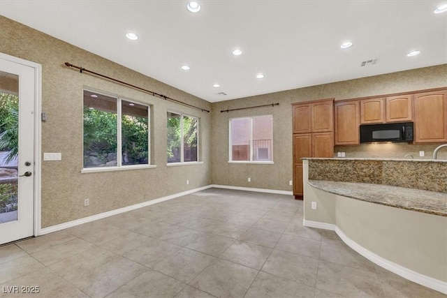 kitchen featuring light stone counters and light tile patterned flooring