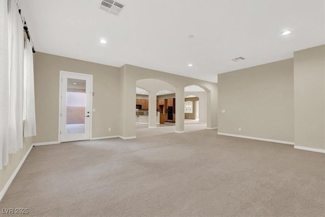 unfurnished living room featuring light colored carpet