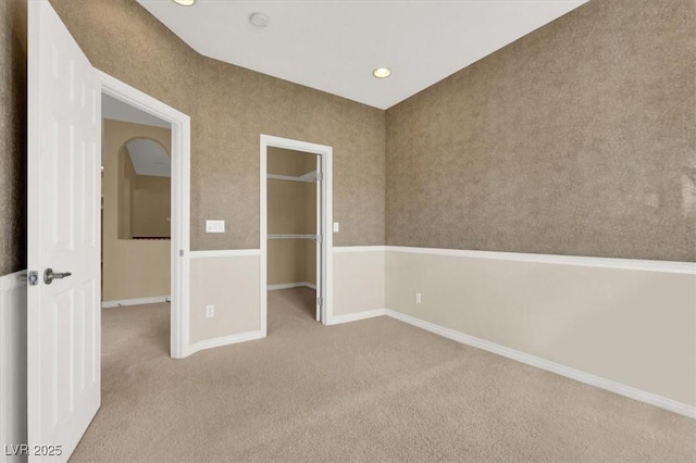 unfurnished bedroom featuring light carpet