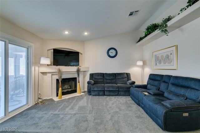 living room featuring carpet floors and a fireplace