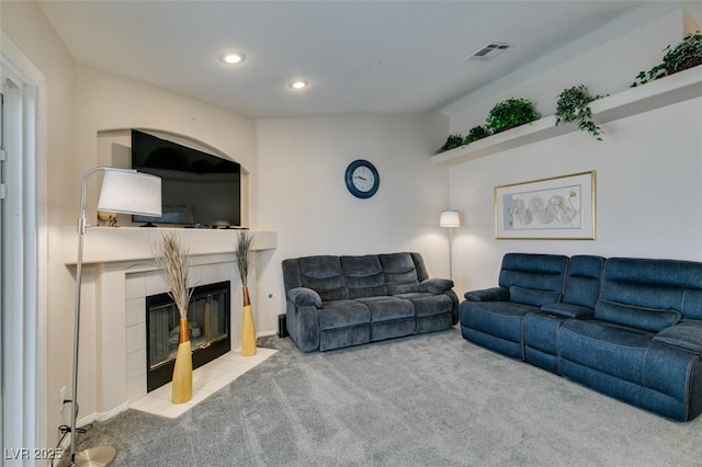 living room featuring a fireplace and light colored carpet