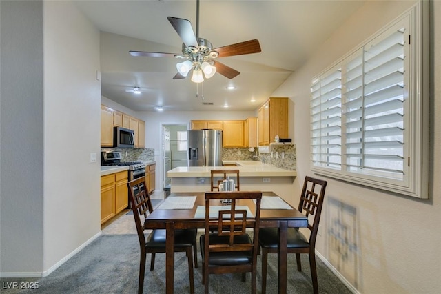 dining area featuring light colored carpet and ceiling fan