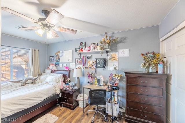 bedroom with ceiling fan and light hardwood / wood-style flooring