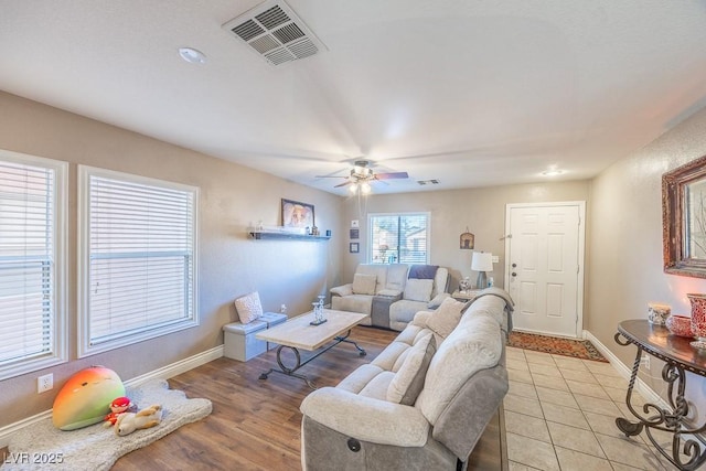 living room with light tile patterned floors and ceiling fan