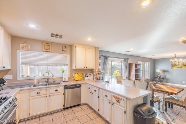 kitchen featuring light tile patterned flooring, appliances with stainless steel finishes, kitchen peninsula, and sink