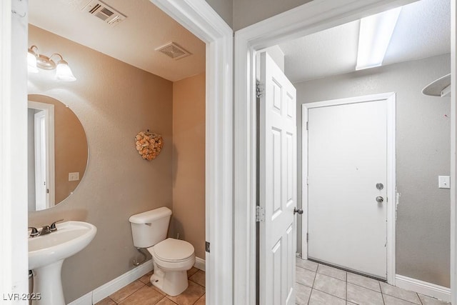 bathroom featuring tile patterned floors and toilet