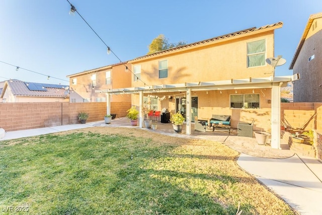 rear view of house with a yard and a patio area