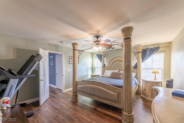 bedroom with ceiling fan, dark hardwood / wood-style flooring, and a textured ceiling