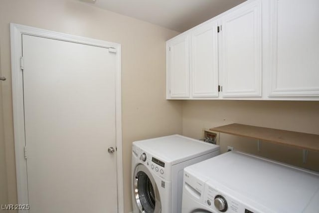 laundry room featuring cabinets and washer and clothes dryer