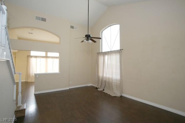 unfurnished living room featuring high vaulted ceiling, dark hardwood / wood-style floors, and ceiling fan