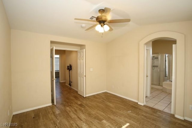 empty room with ceiling fan and hardwood / wood-style floors