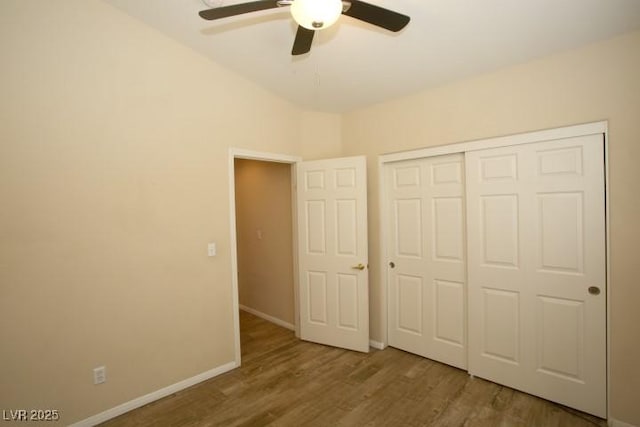 unfurnished bedroom featuring wood-type flooring, ceiling fan, and a closet