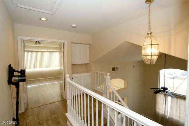 hallway with hardwood / wood-style floors