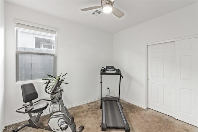 exercise room featuring ceiling fan and light colored carpet