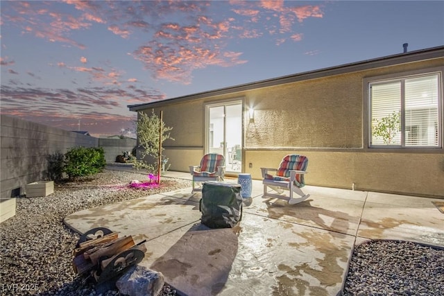 view of patio terrace at dusk