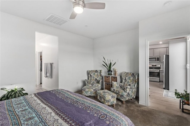 bedroom featuring carpet flooring, stainless steel fridge, and ceiling fan