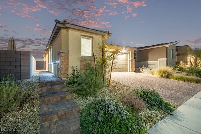 property exterior at dusk with a garage