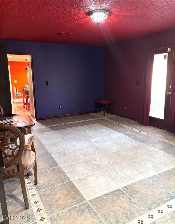 unfurnished room featuring a textured ceiling