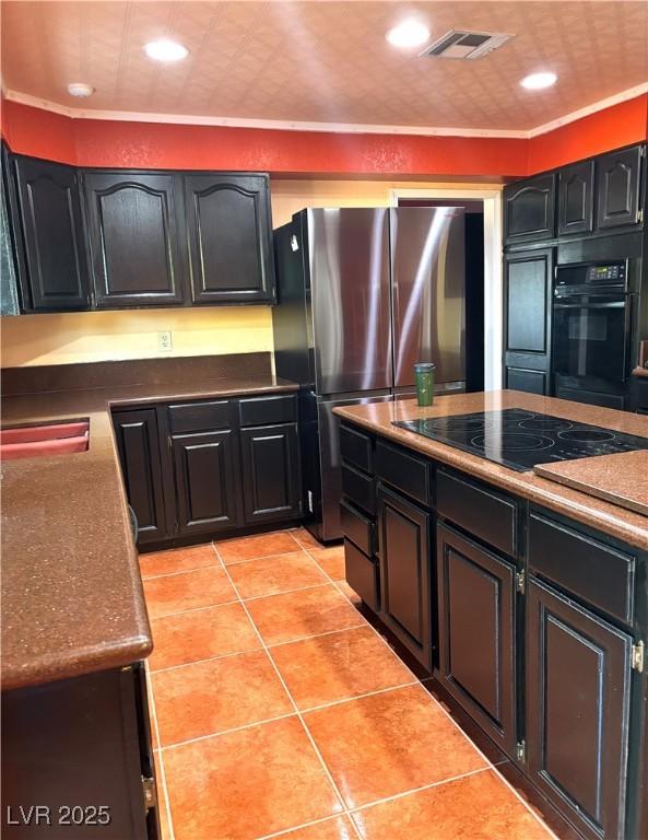 kitchen with light tile patterned floors, ornamental molding, black appliances, and sink