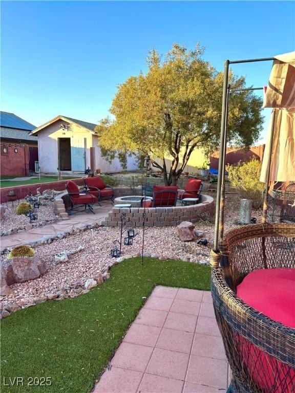 view of yard featuring an outdoor structure and a patio area