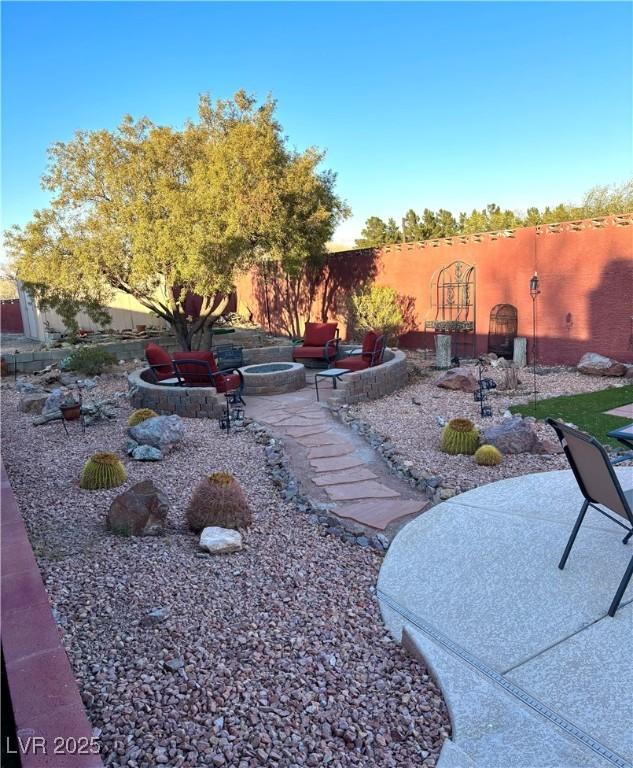 view of yard with a fire pit and a patio