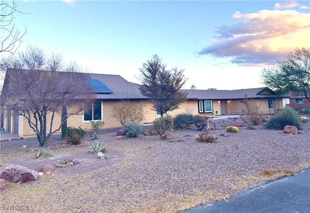 ranch-style house with solar panels