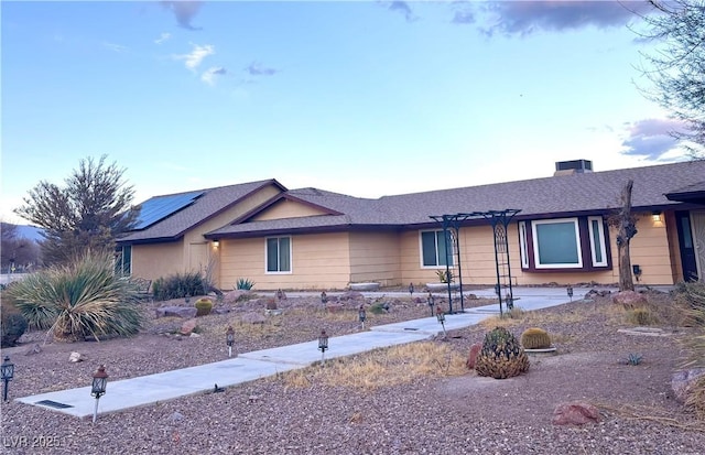 ranch-style home featuring a pergola