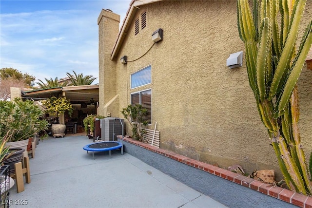 view of home's exterior featuring a patio and cooling unit