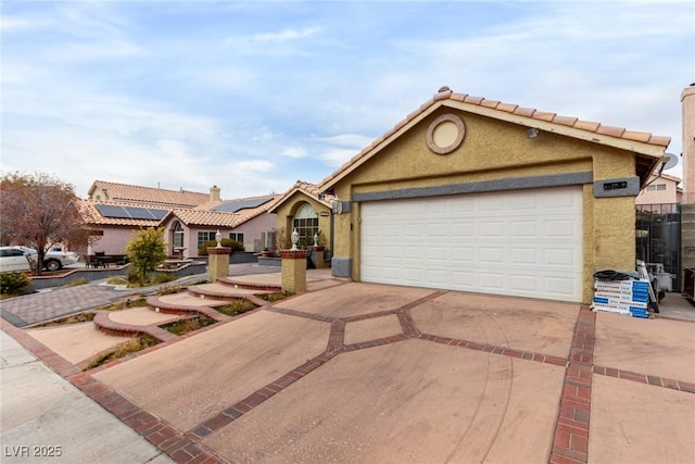 view of front of property featuring a garage and solar panels