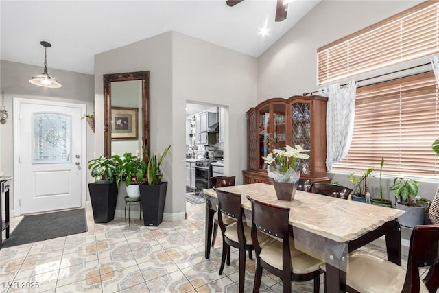 dining space with ceiling fan and lofted ceiling