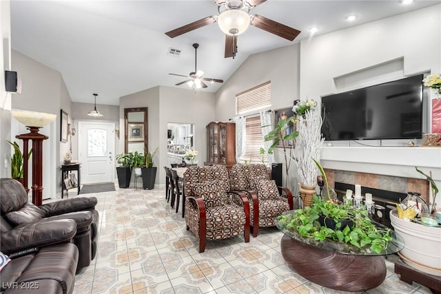 living room featuring vaulted ceiling, plenty of natural light, and ceiling fan