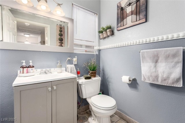 bathroom featuring vanity, tile patterned floors, and toilet