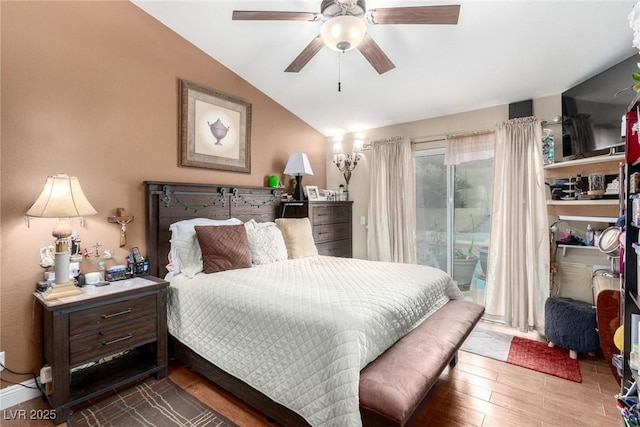 bedroom featuring hardwood / wood-style floors, vaulted ceiling, access to outside, and ceiling fan