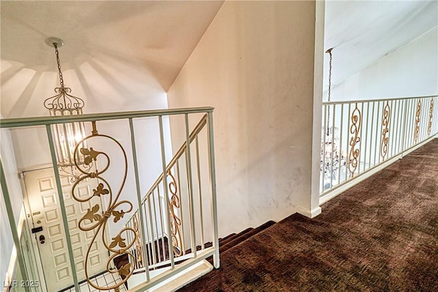 stairway with lofted ceiling, a notable chandelier, and carpet