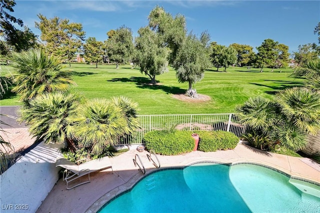 view of pool with a yard