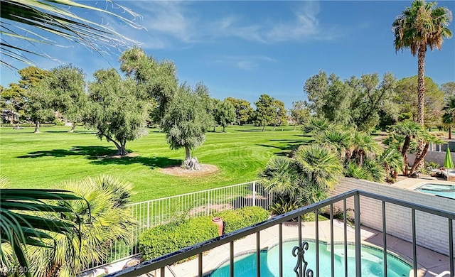 view of swimming pool featuring a hot tub and a yard