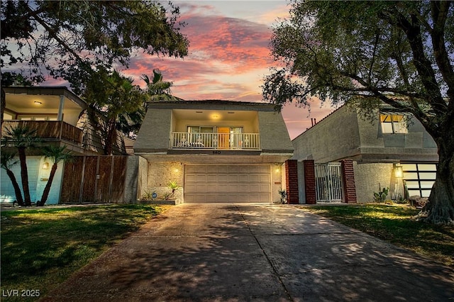 view of front of property featuring a garage and a balcony