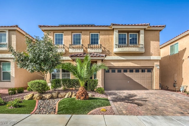 mediterranean / spanish-style home with a balcony and a garage