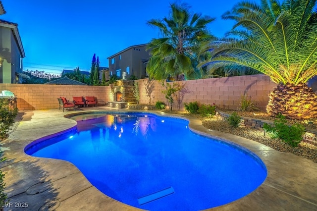 view of pool featuring exterior fireplace and a patio area