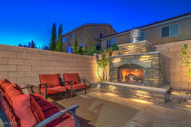 view of patio featuring an outdoor stone fireplace