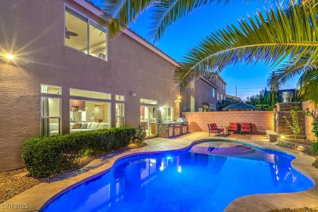 view of swimming pool featuring an outdoor kitchen