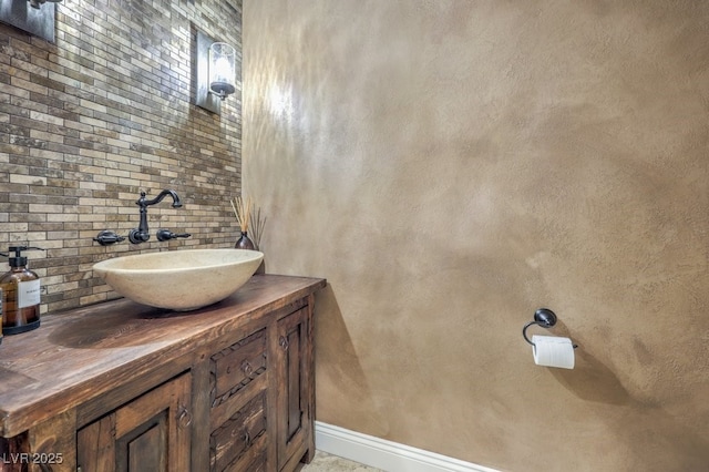 bathroom with vanity and tasteful backsplash