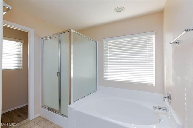 bathroom featuring independent shower and bath