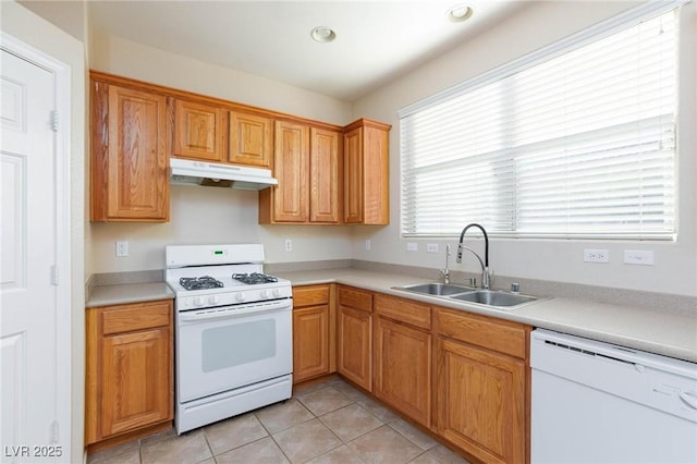 kitchen with light tile patterned flooring, white appliances, and sink