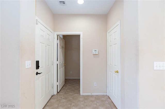 hall with light tile patterned flooring