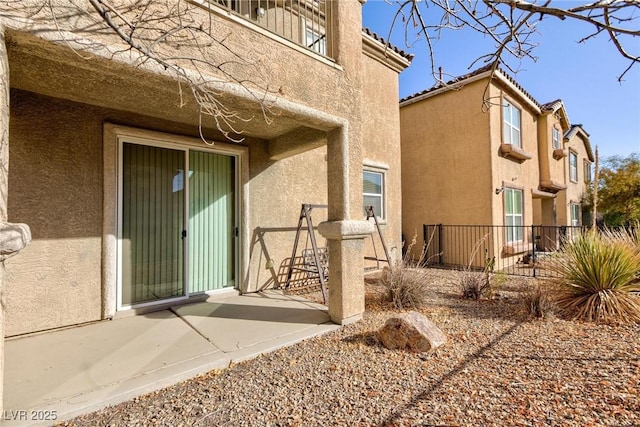 view of exterior entry featuring a patio