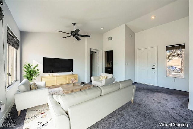 carpeted living room featuring ceiling fan and high vaulted ceiling