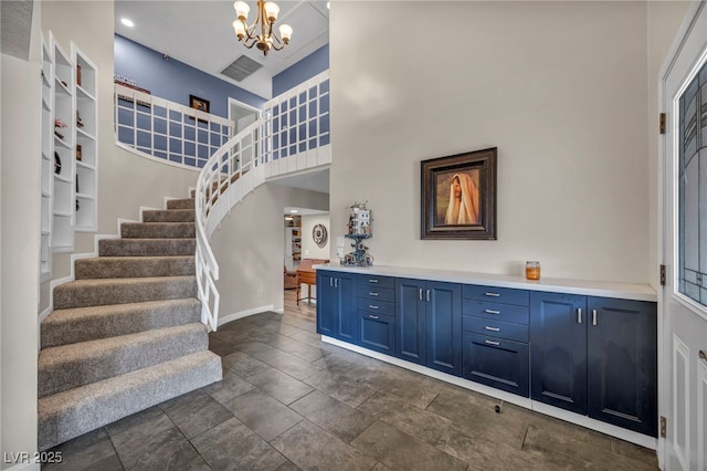 foyer entrance featuring an inviting chandelier and a high ceiling