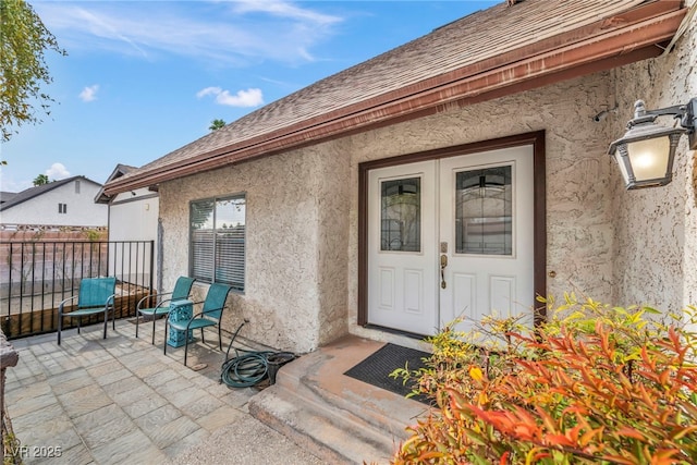 entrance to property featuring a patio and french doors