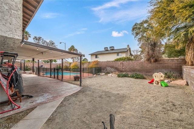 view of yard featuring a fenced in pool and a patio